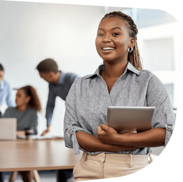 a-smiling-lady-holding-an-ipad-with-people-behind-her